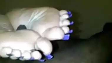 Indian woman with long toenails giving footjob